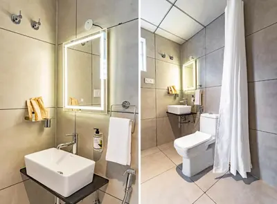 a bathroom with a sink and a toilet at Treebo Global Orchid in Mysore