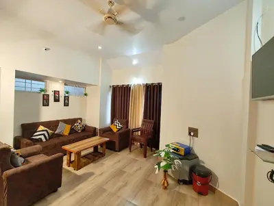 a living room with a couch and a table at Galasy in Narasimharaja Puram