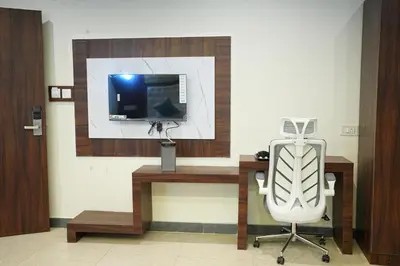 a office with a desk with a computer and a chair at Elite Group Mysore in Mysore