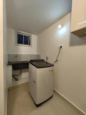 a kitchen with a small refrigerator in a room at Namasv 2BHK AC House in Narasimharaja Puram