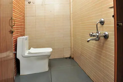 a bathroom with a toilet in a stall at Alfa Tourist Home, Batheri in Sultan Bathery