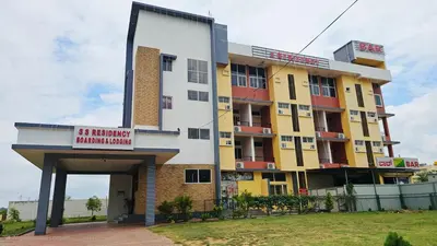 a building with a sign in front of it at Corcordium by ssr in Bilikere