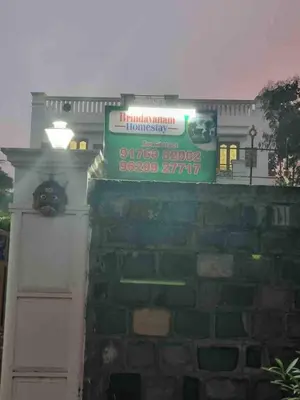 a sign on top of a brick wall at Brindavanam HomeStay Salem in Salem
