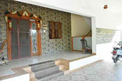a room with a staircase and a motorcycle parked in it at Brindavanam HomeStay Salem in Salem