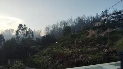 a person standing on the side of a hill at The Dew Nest in Ooty
