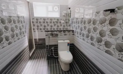 a bathroom with a toilet in a room at Prithivee Homestay in Kotagiri