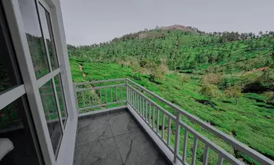 a balcony with a view of a mountain at Prithivee Homestay in Kotagiri