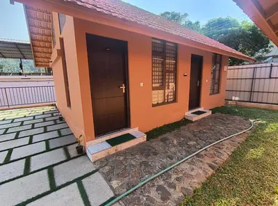 a small house with a hose outside of it at Mystic Rock Staycations in Mannārakkāt