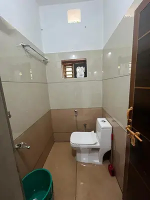 a small bathroom with a toilet and a window at Idachirakkal homestay in Palghat