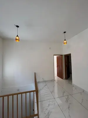 a hallway with two lights on a white wall at Idachirakkal homestay in Palghat