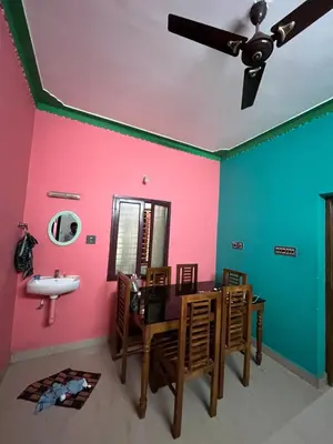 a bathroom with pink and green walls and a sink at Idachirakkal homestay in Palghat