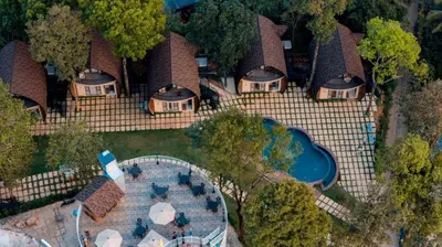 an aerial view of a house with a swimming pool at Golf Valley Luxury Resort Wayanad in Vythiri