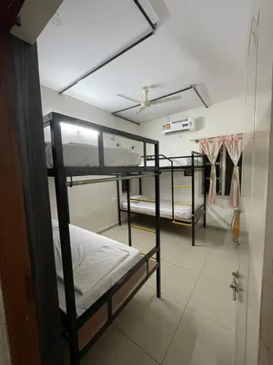 a room with three bunk beds and a closet at AAKI Comforts in Mysore