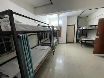 a room with three bunk beds and a hallway at AAKI Comforts in Mysore
