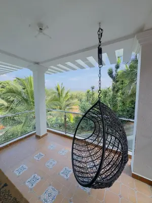 a swing hanging from a ceiling in a house at WhiteLilys Pool Retreat Kaggodlu Madikeri Coorg in Madikeri