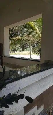a window in a room with a view of a tree at BharathaPuzha Villa in Kārakkād