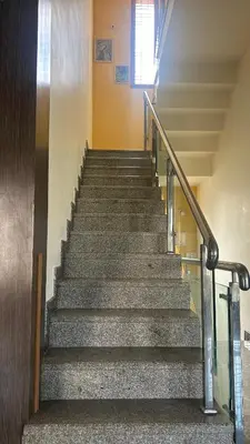 a set of stairs in a building with a window at Aalaya in Mysore