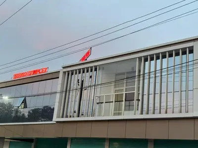 a building with a chinese flag on top of it at Zeekka Tourist Home in Meenangadi