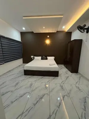 a bedroom with a bed with a marble floor at Zeekka Tourist Home in Meenangadi