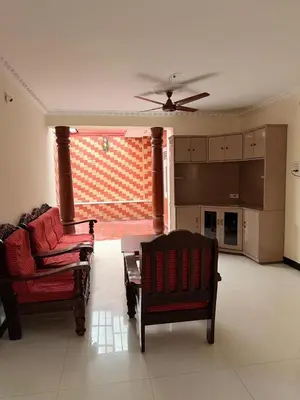 a living room with two chairs and a couch at Cheerful - homes Mysore stay in Mysore