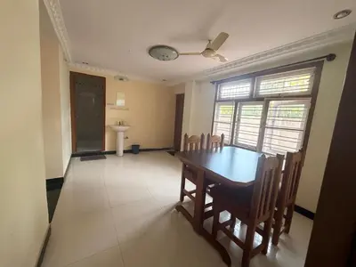 a dining room with a wooden table and chairs at Cheerful - homes Mysore stay in Mysore