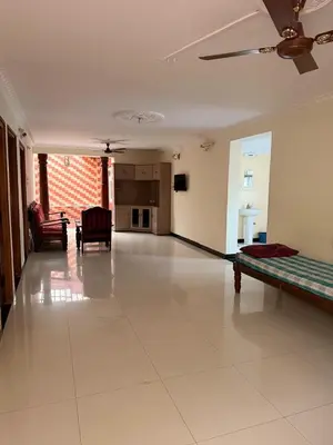 a large living room with a couch and a living room at Cheerful - homes Mysore stay in Mysore
