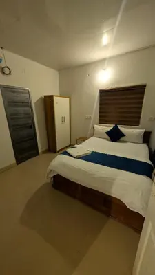 a bedroom with a large bed with a wooden headboard at Vihara Inn Resort in Vayittiri