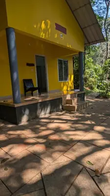 a yellow building with a bench in front of it at Vihara Inn Resort in Vayittiri