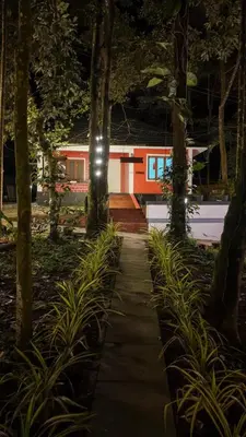 a walkway in front of a house at night at Vihara Inn Resort in Vayittiri