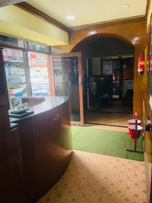 a room with a counter and a room with a hallway at budget stay-mystique inn in Ooty