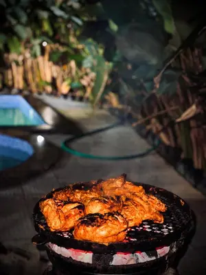 a grill with some food on top of it at Alora villas in Wayanad