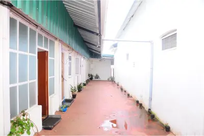 an empty hallway of a building with a long floor at Kitty Royal Inn in Ooty