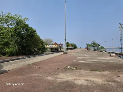 an empty street next to the water with a pole at Aqua Vista beach home's in Cochin