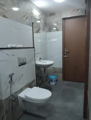 a bathroom with a toilet and a sink at Amaira Studio living - Coimbatore in Coimbatore