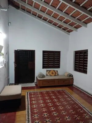 a living room with a bed and a rug at Nalee Farm Stay in Hunsūr