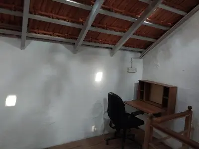 a desk in a room with a chair and a computer at Nalee Farm Stay in Hunsūr