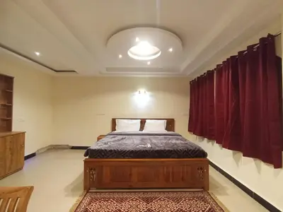 a bedroom with a bed in a room at The Hill Bunk Heights Ooty in Ooty