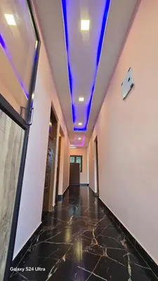 a hallway with a blue ceiling in a building at Azhagumail Honey Resort Kanthalloor in Kanthalloor