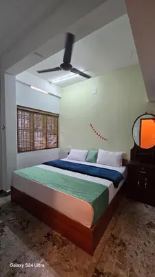 a bedroom with a bed and a tv in it at Azhagumail Honey Resort Kanthalloor in Kanthalloor