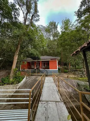 a house with a fence in front of it at Rockview in Kalpetta