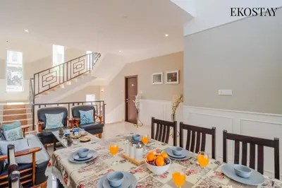 a dining room with a table with oranges on it at EKOSTAY - Apollo Villa in Kodaikānāl