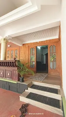 a room with a door and a pair of shoes at RJ Residency in Kozhikode