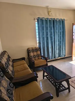 a living room with two chairs and a couch and a table at Ahavah Chalets in Ketti
