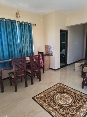 a living room with a table and chairs and a rug at Ahavah Chalets in Ketti