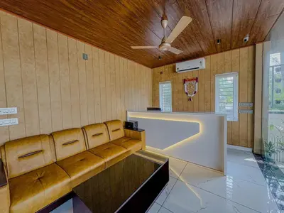 a living room with a couch and a ceiling fan at Rajagiri View Apartments in Alwaye