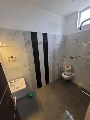 a bathroom with a sink and a toilet at Rajagiri View Apartments in Alwaye