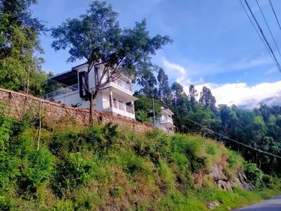 a house on the side of a hill at Amber Mount Resorts in Kanthalloor