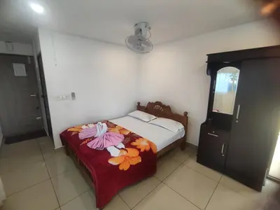 a bedroom with a bed with flowers on it at Ponkunnu Farmstay and Resorts - Emerald - The Tree House - First Floor in Bālūssheri