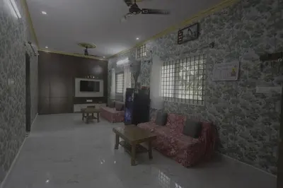 a living room with two couches and a tv at Coconut Sooru,Managed By Triora Escapes in Maddūr