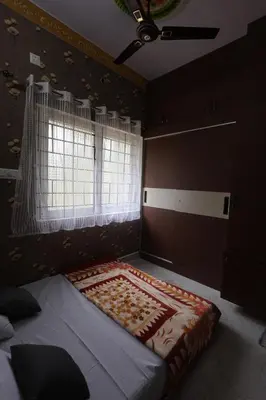 a bedroom with a large bed with a window at Coconut Sooru,Managed By Triora Escapes in Maddūr